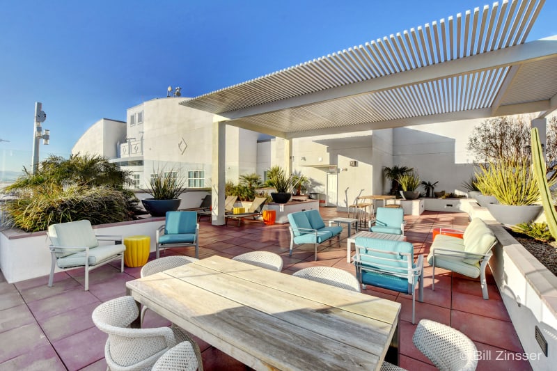The Ogden Rooftop Deck with lounge seating and mountain views